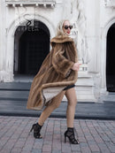 Brown mink fur coat with hood and wide collar, draped front, mid-calf length