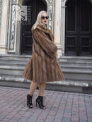 Vintage mink fur coat with hood, brown flared hem, 3/4 front view