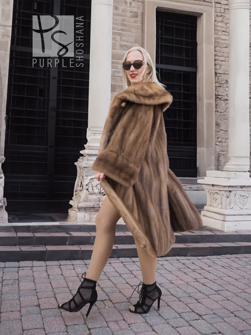Vintage mink fur coat with hood, brown long hem, angled side view