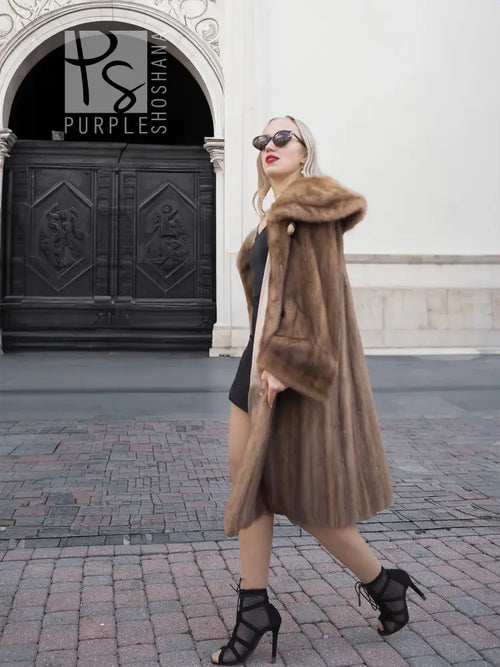 Brown mink fur coat with hood, mid-calf length, open front and textured fur.