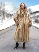Long hooded fur coat in tan and brown with buttonless front and textured sleeves.