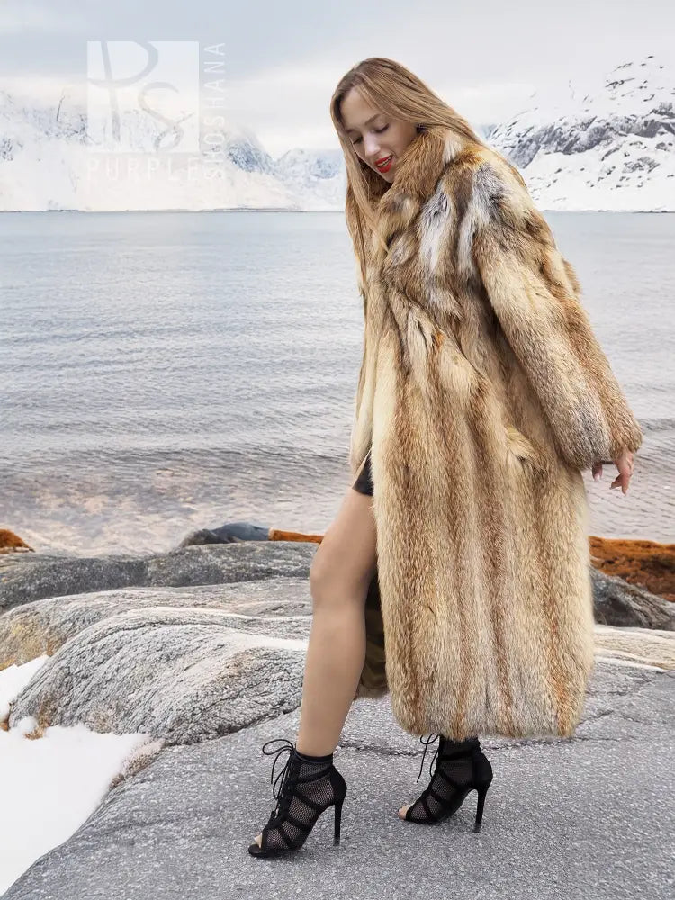 Long tan fur coat with open front; model angled side view, hands by sides.
