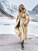 Long hooded fur coat in tan and brown, open front showing inner lining and slit.