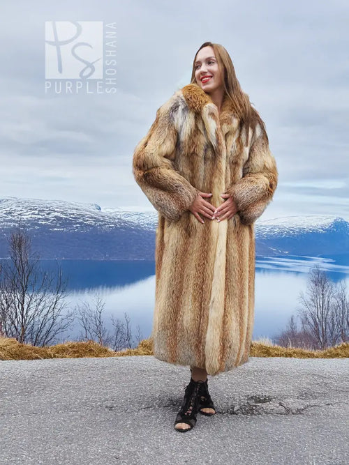 Long hooded tan-and-brown fur coat with deep collar and open front, long length.