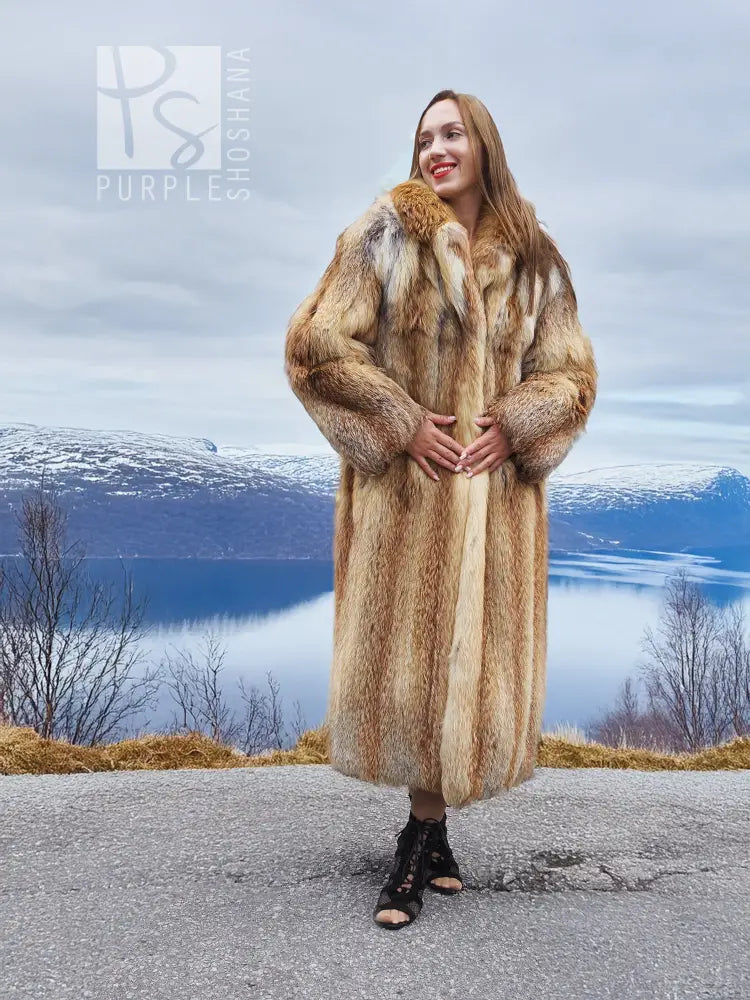 Long hooded tan-and-brown fur coat with deep collar and open front, long length.