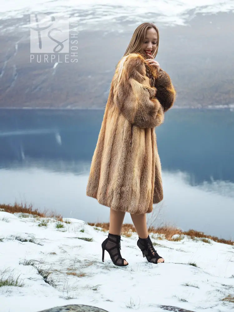 Tan fur coat with open front and large collar, three-quarter view.