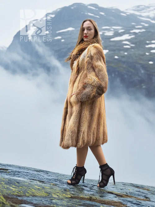 Tan fur coat with long sleeves and textured fur panels, side profile.