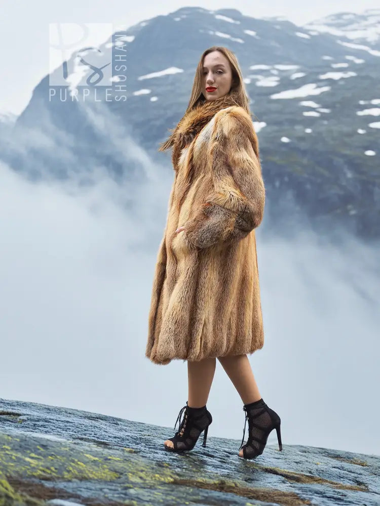 Tan fur coat with long sleeves and textured fur panels, side profile.