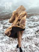 Fox fur coat in side view, draped shoulders and open black panel
