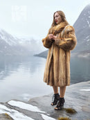 Tan fur coat with thick collar and long sleeves, front view at side angle.
