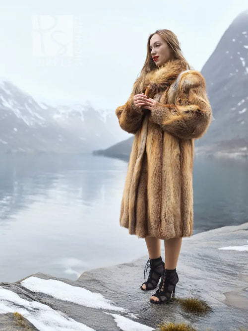 Tan fur coat with thick collar and long sleeves, front view at side angle.