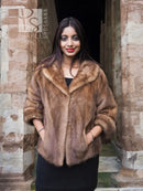 Beige mink fur opera jacket, cropped cut with shawl collar and open front.
