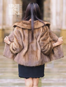 Beige mink fur opera jacket back view, voluminous fur with shawl collar.