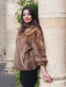 Beige mink fur opera jacket with shawl collar, three-quarter length sleeves.