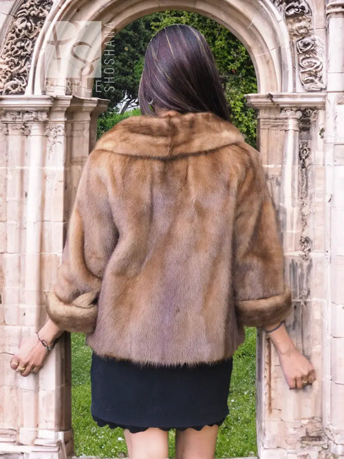 Beige mink fur opera jacket, back view with shawl collar and short hem.