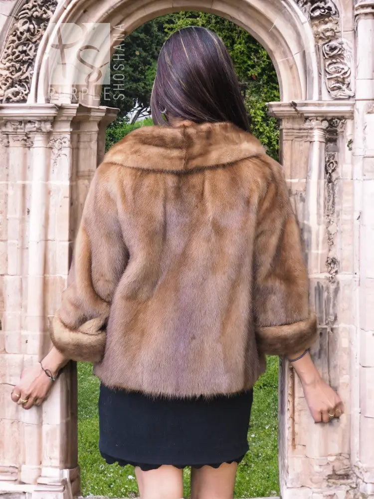 Beige mink fur opera jacket, back view with shawl collar and short hem.
