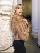 Pastel beige mink fur opera jacket, side profile with curved collar and cuffs