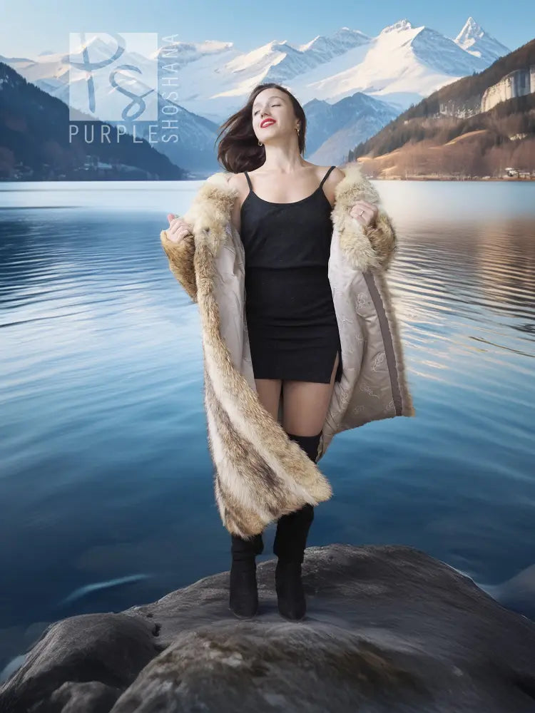 Tan faux fur coat with shawl collar, long sleeves and open front over a black dress