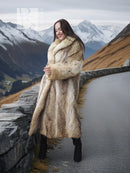 Long tan faux fur coat with shawl collar, worn with black boots and a black mini dress