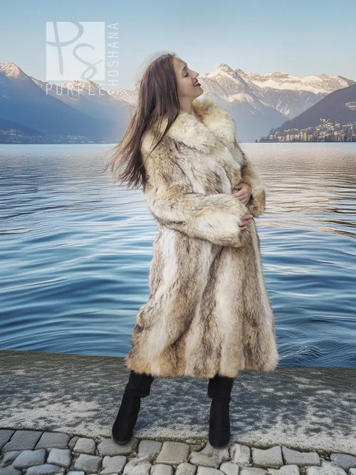 Tan faux fur coat with shawl collar and full length hem, styled with black knee-high boots
