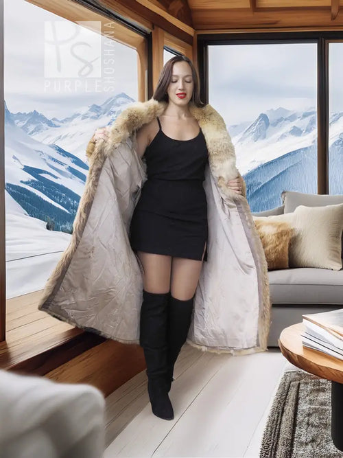 Beige fur coat with shawl collar, open front styling, long sleeves, knee length.