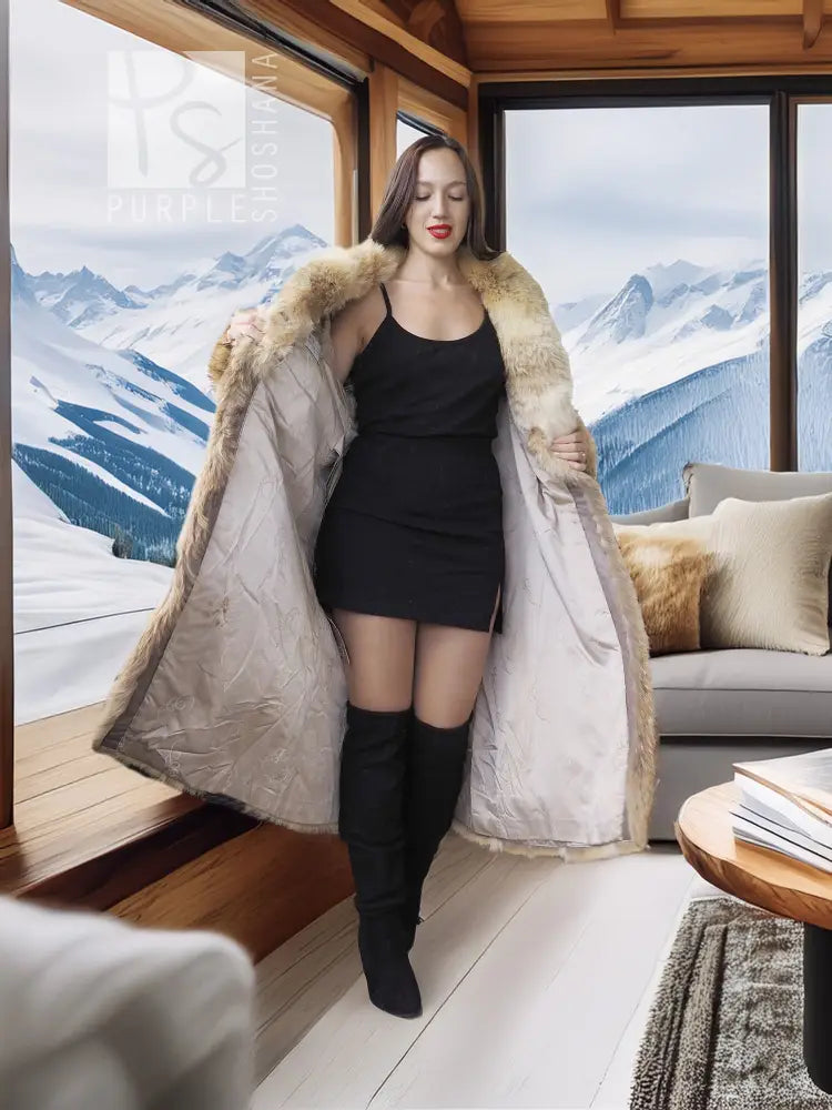 Beige fur coat with shawl collar, open front styling, long sleeves, knee length.